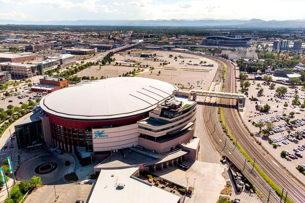 A circular building with a parking lot surrounding it.