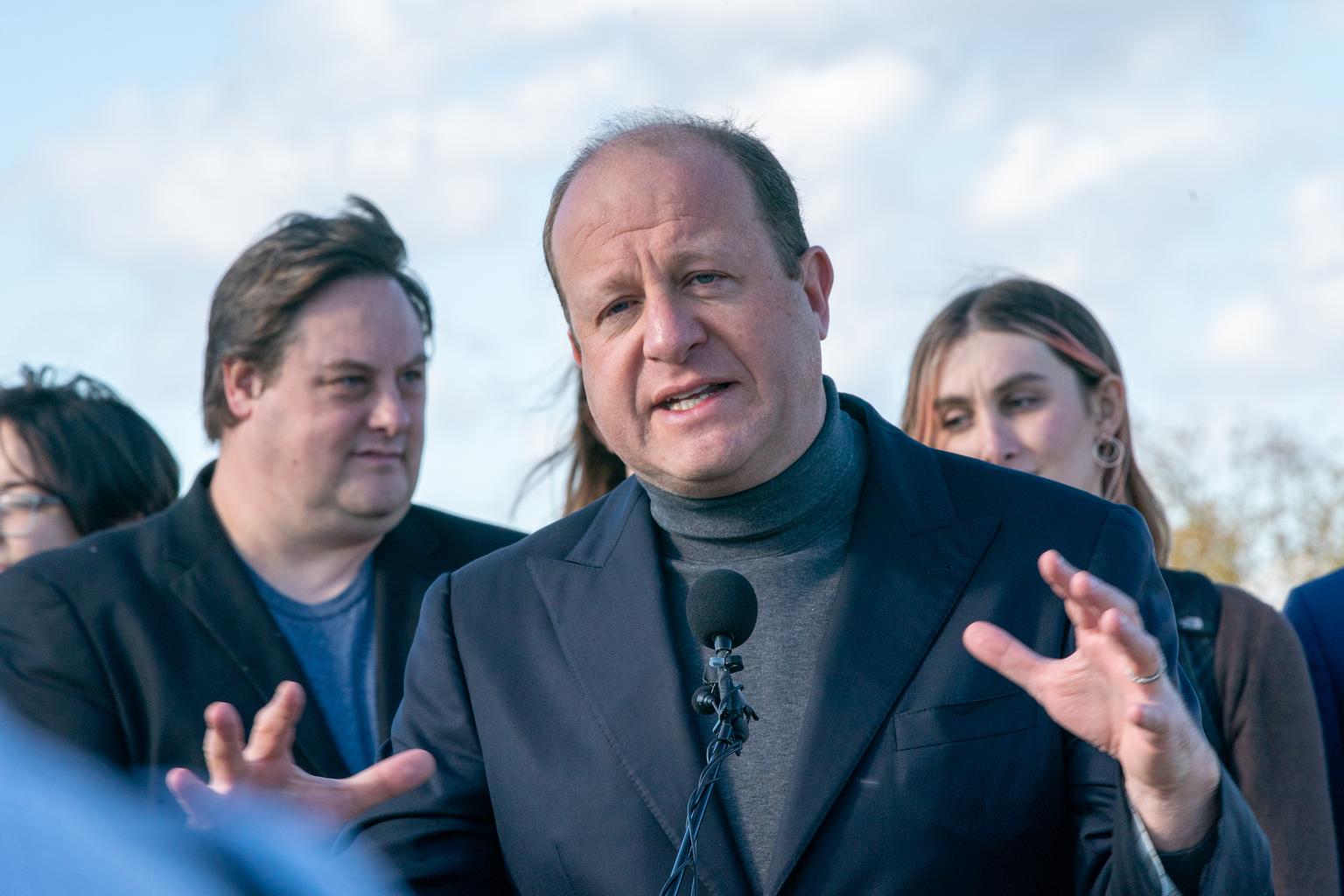 Colorado Governor Jared Polis gestures during a press conference