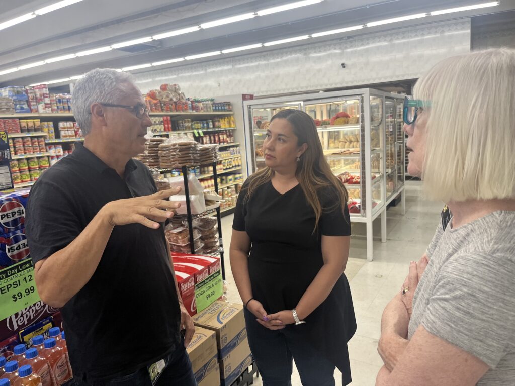 Democratic Rep. Yadira Caraveo talks with the owner of Los Comales Market in Greeley