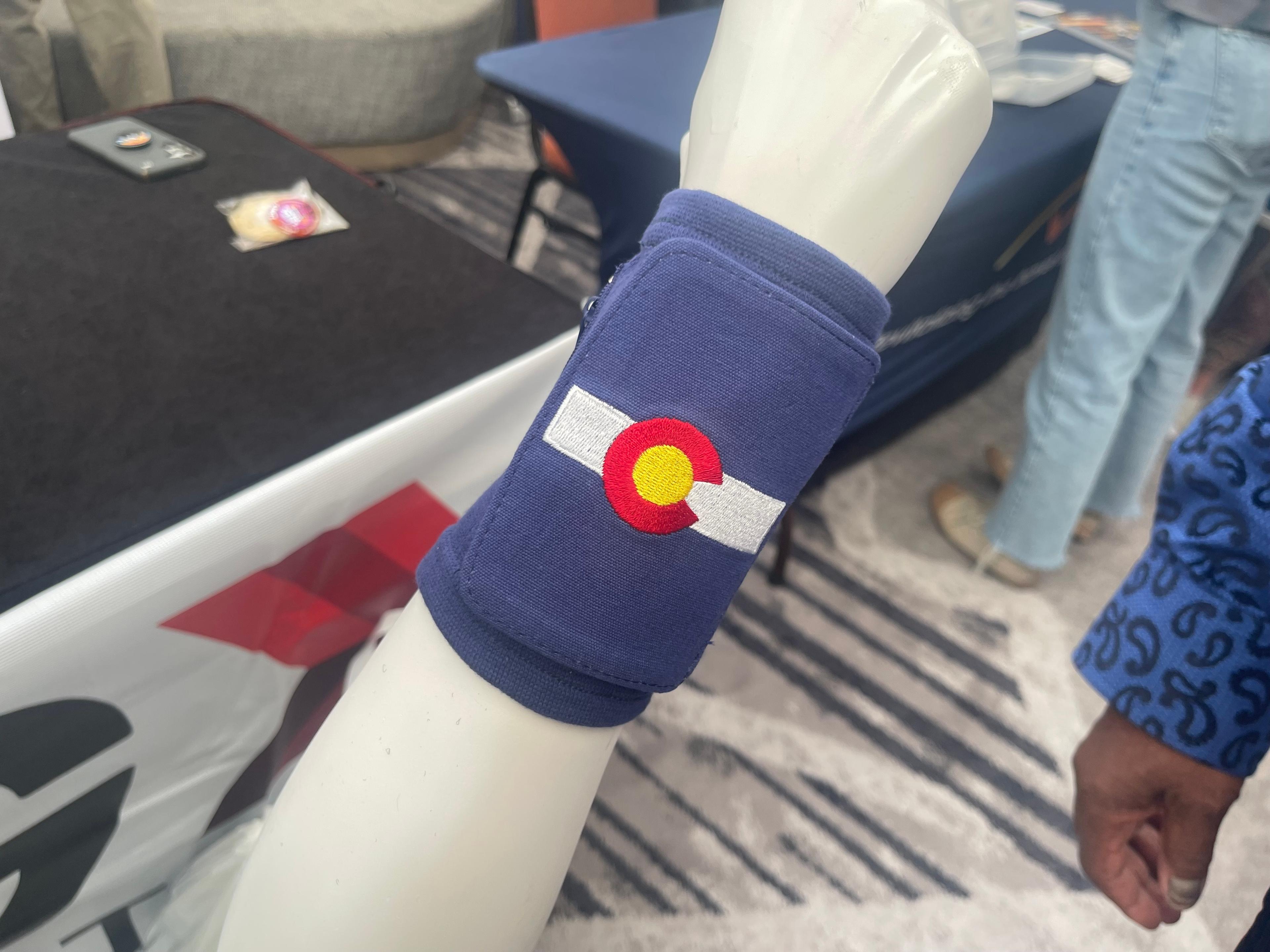 A blue wrist wallet emblazoned with the Colorado flag