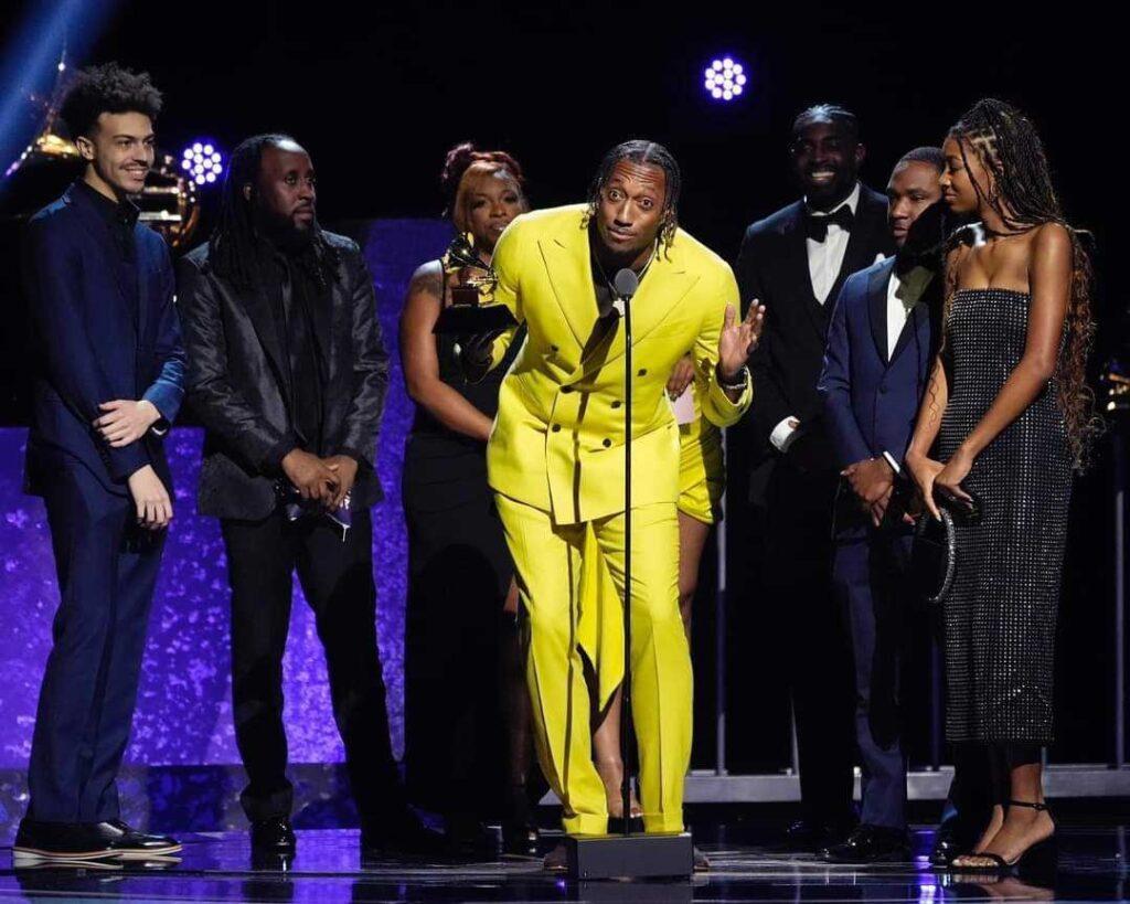 Christian rapper Lecrae is seen on stage at the 2024 Grammy awards giving an acceptance speech.