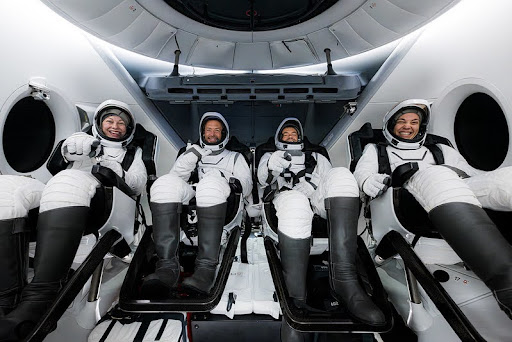 Polaris Dawn astronauts are seen sitting side by side inside the Crew Dragon capsule. From left Anna Menon, Scott “Kidd” Poteet, Jared Isaacman, and Sarah Gillis.