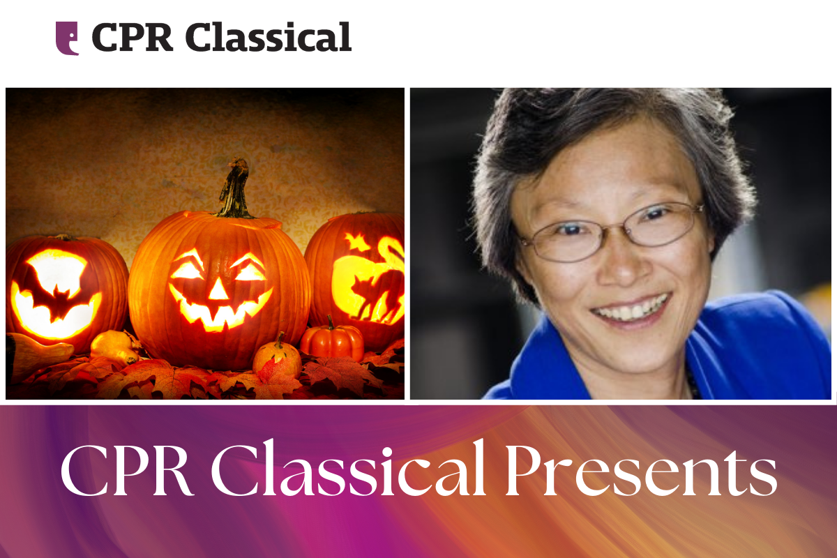 Two carved jack-o-lantern pumpkins and a picture of a woman in a blue jacket.