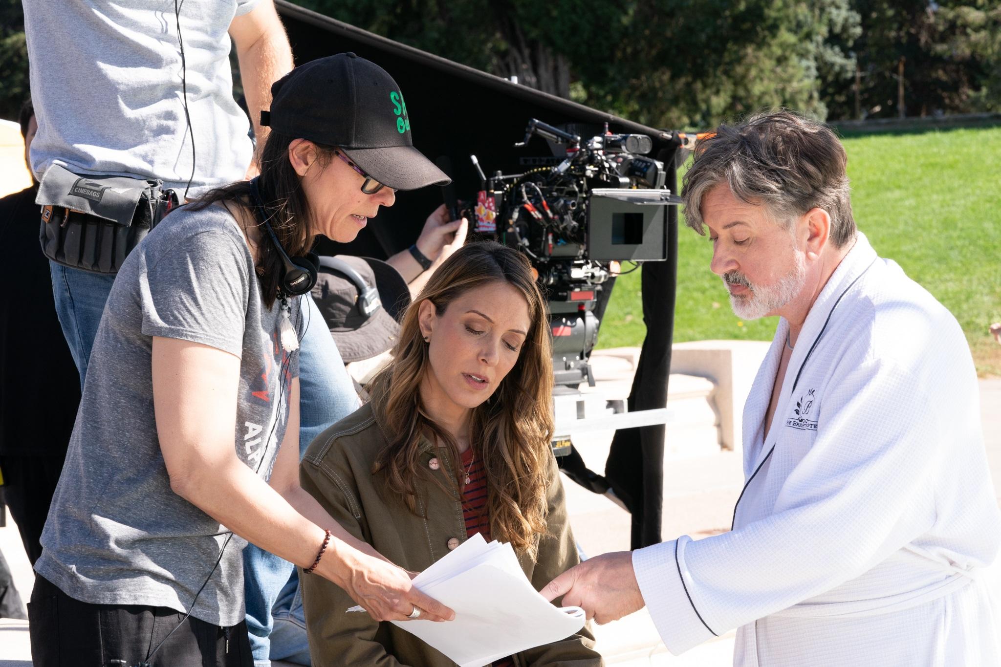 Actors Natalie Gold and Jeremy Swift are pictured going over a script with director/co-writer Sheryl Glubok on the set of "Welcome to the Fishbowl."