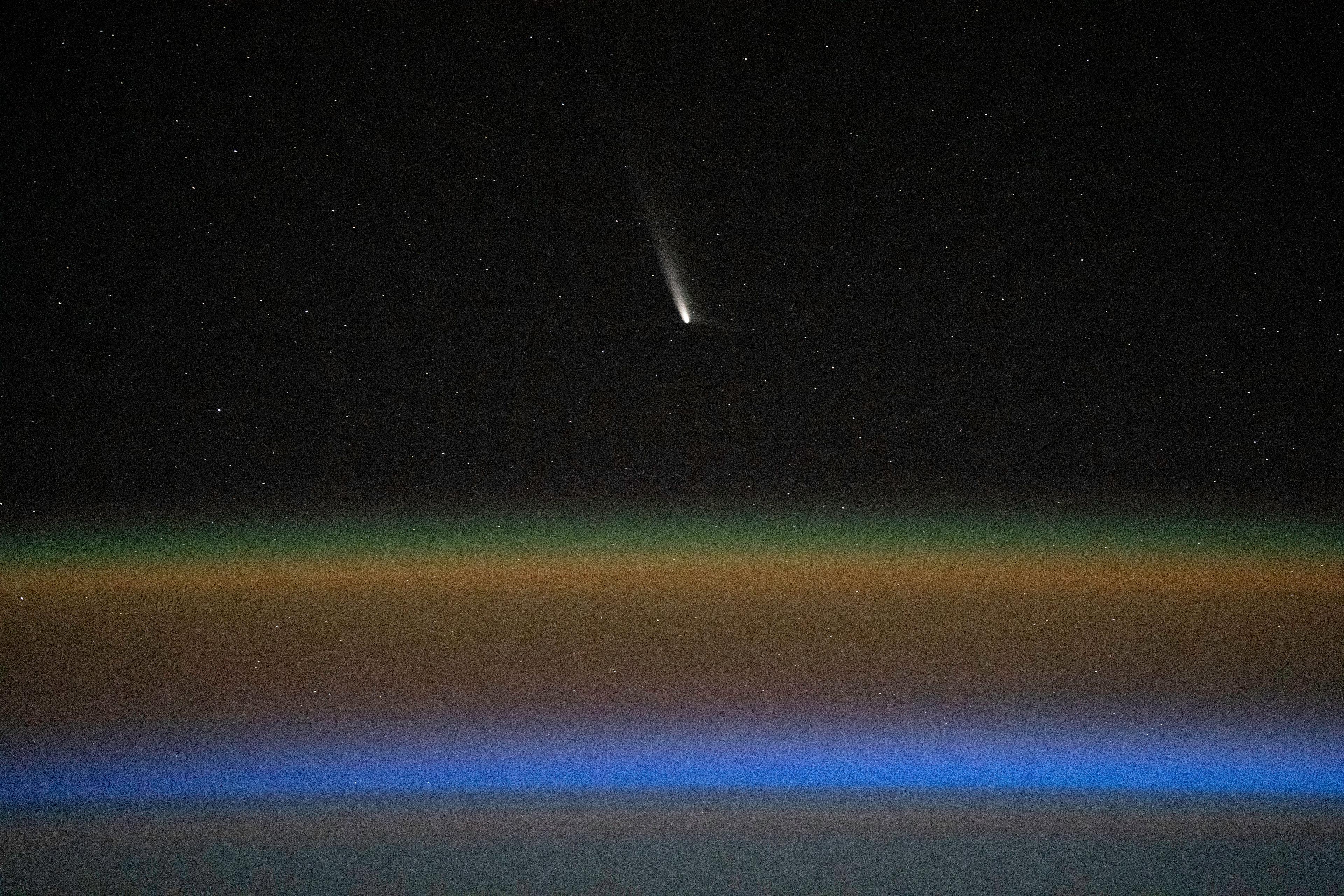 The Tsuchinshan-ATLAS comet is shown streaking through space near the Earth as seen from the International Space Station.