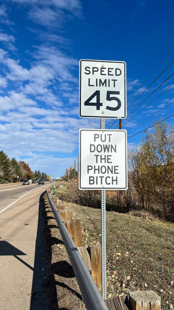 An unauthorized, profane street sign along a highway