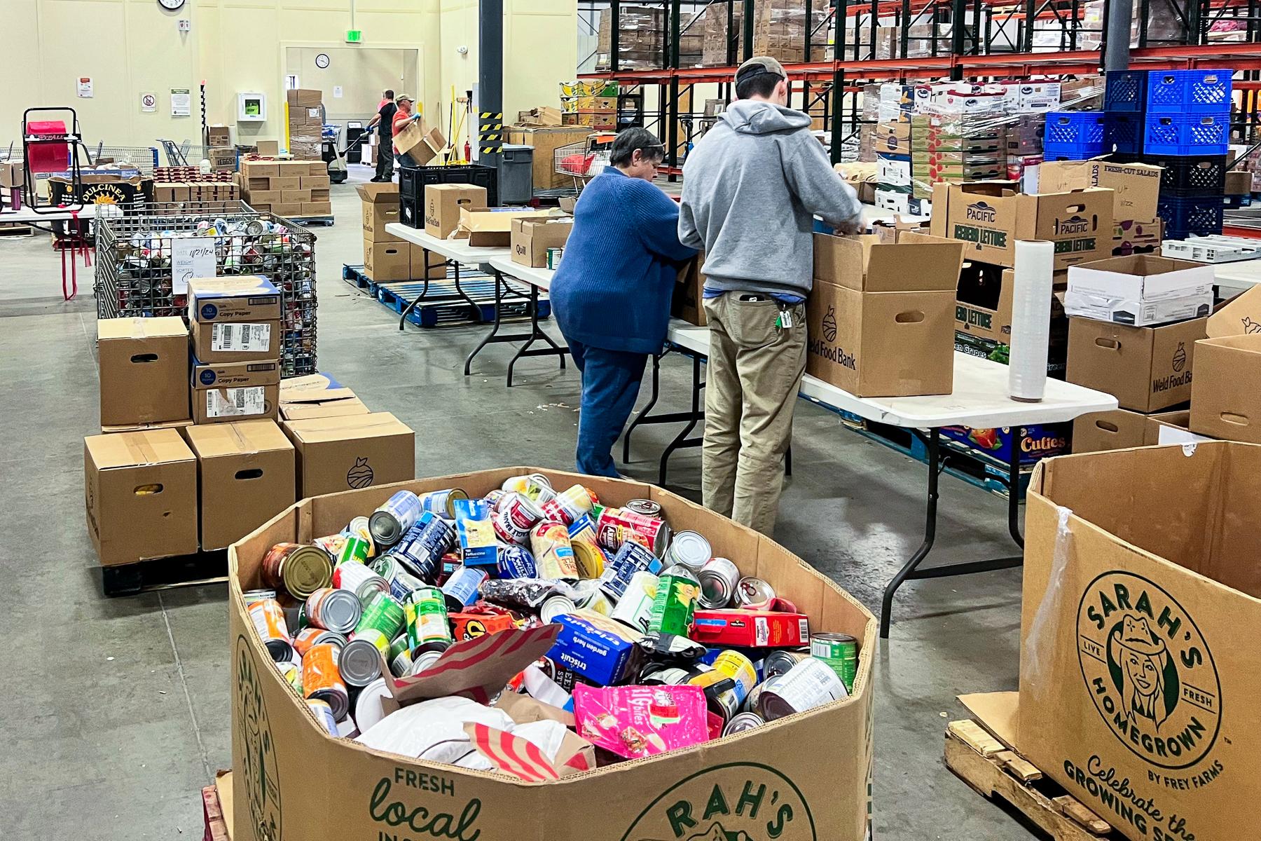 Volunteers sort through donations to make Thanksgiving Boxes