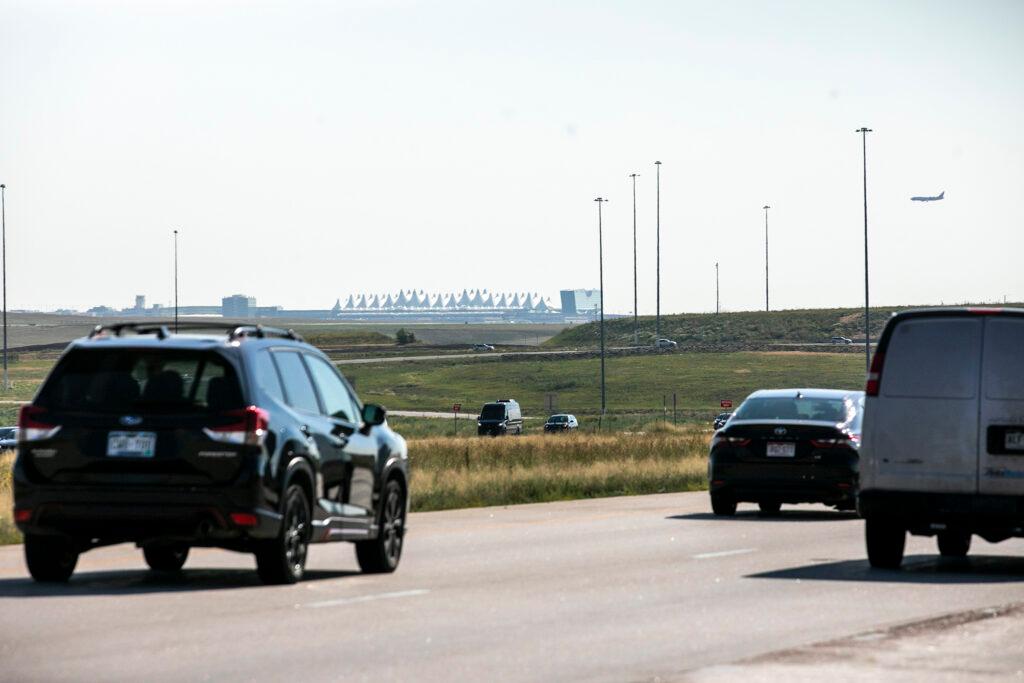 Cars drive over Peña Boulevard. Aug. 24, 2023.