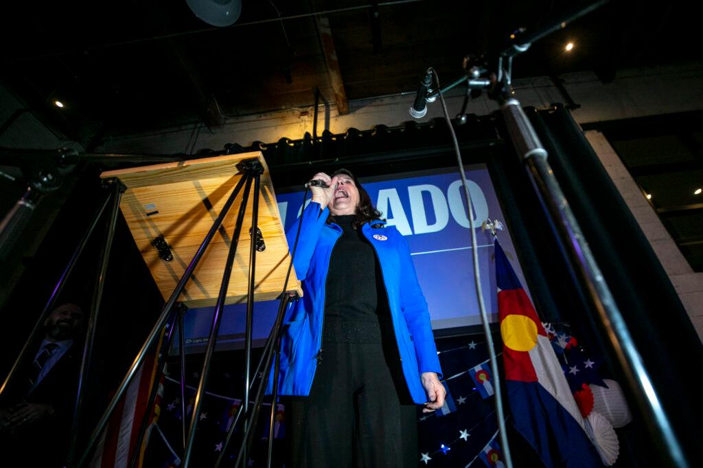 Rep. Diana DeGette standing at a podium with a microphone.