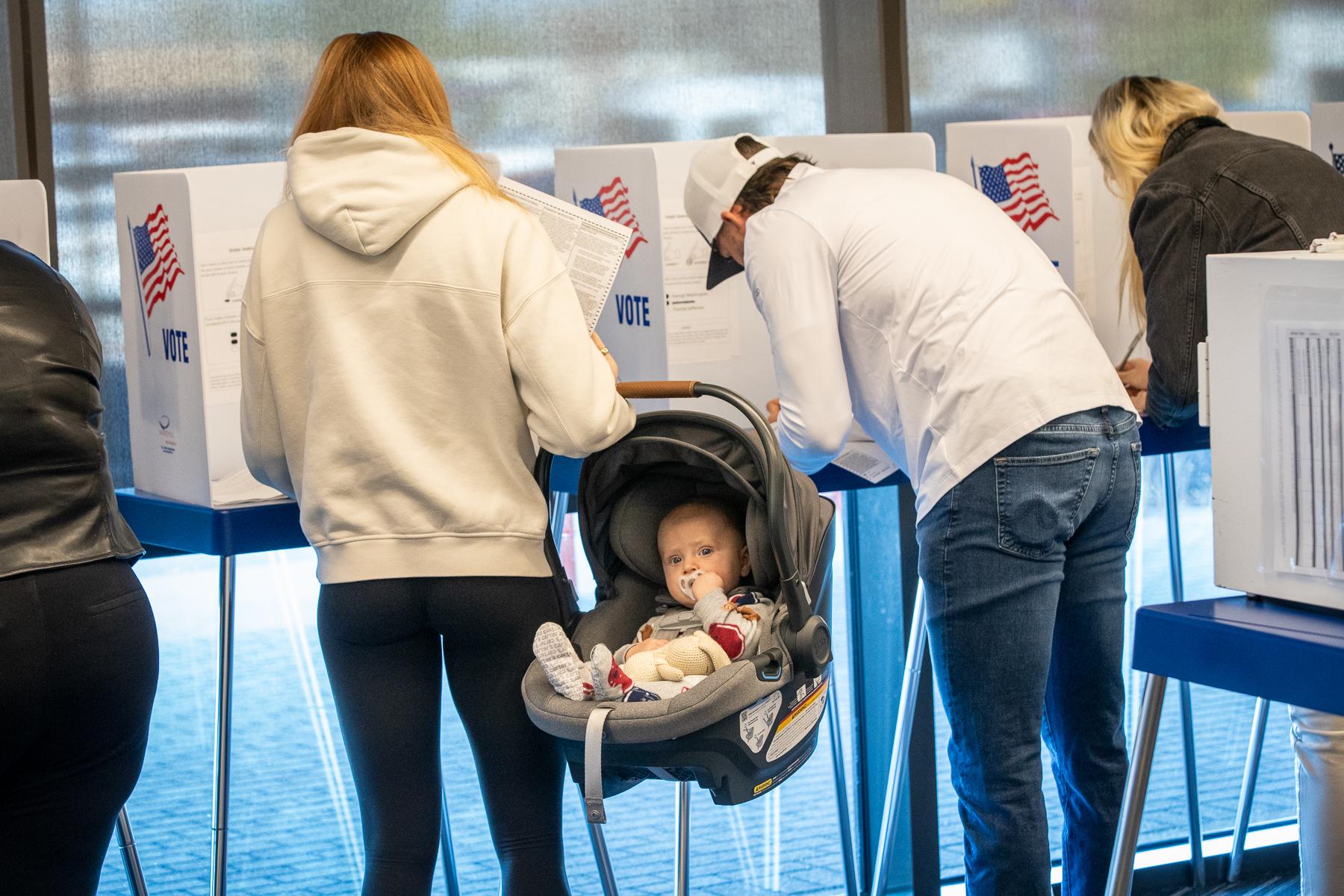 Mom and dad vote in Castle Rock while their baby waits