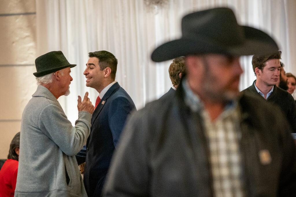 Republican candidate for Congress Gabe Evans shares a light moment with supporter Allen Campbell