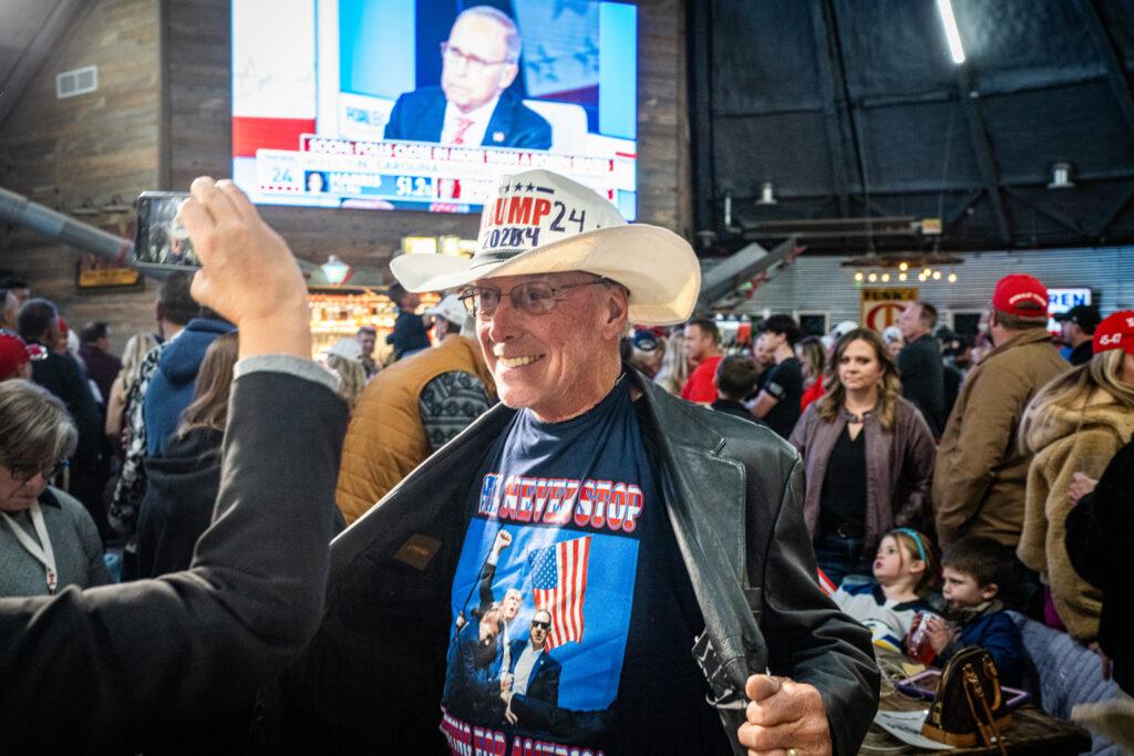 Republican activist David Cook shows off his Donald Trump cowboy hat and t-shirt