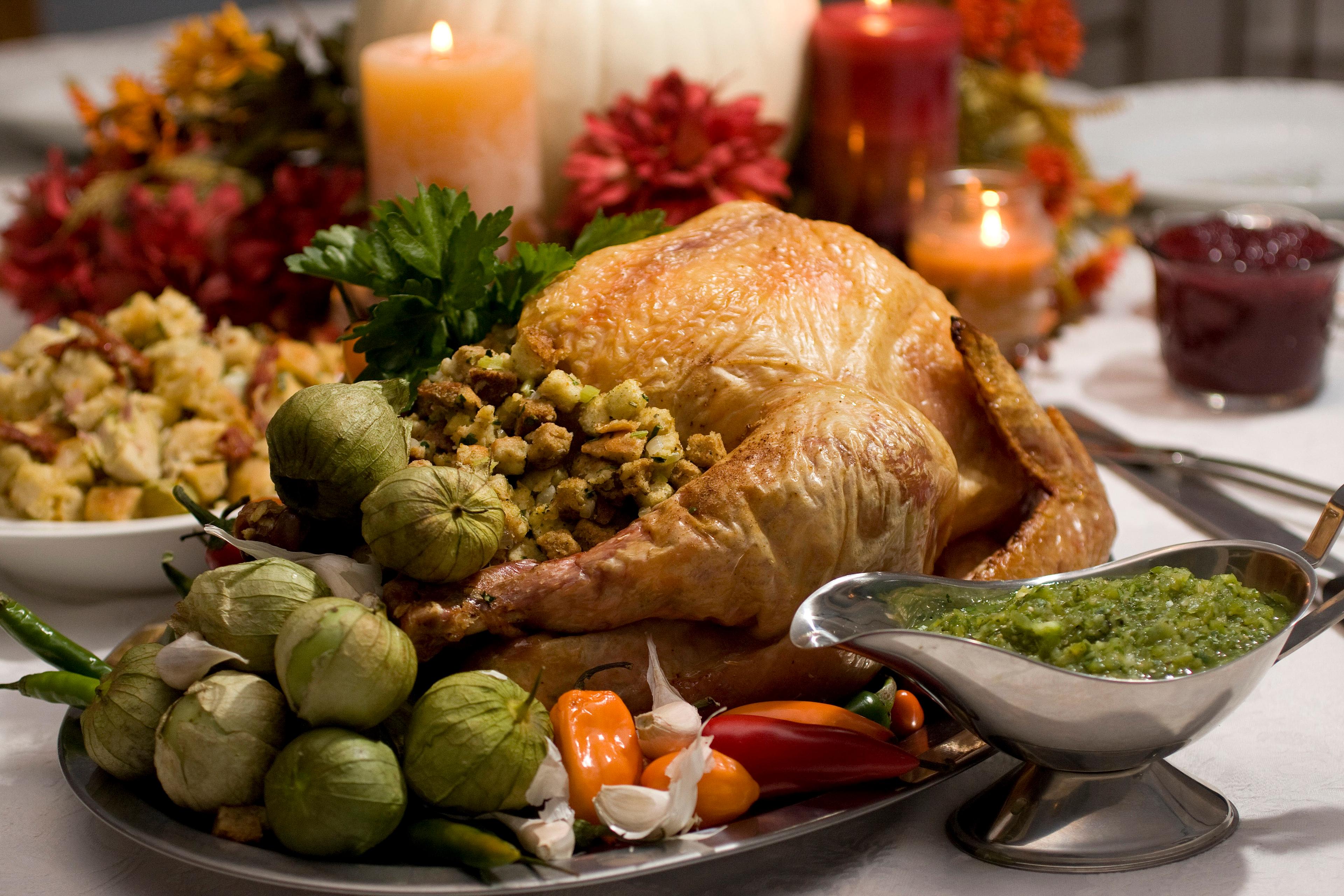 A grill-roasted brined turkey is presented on a table