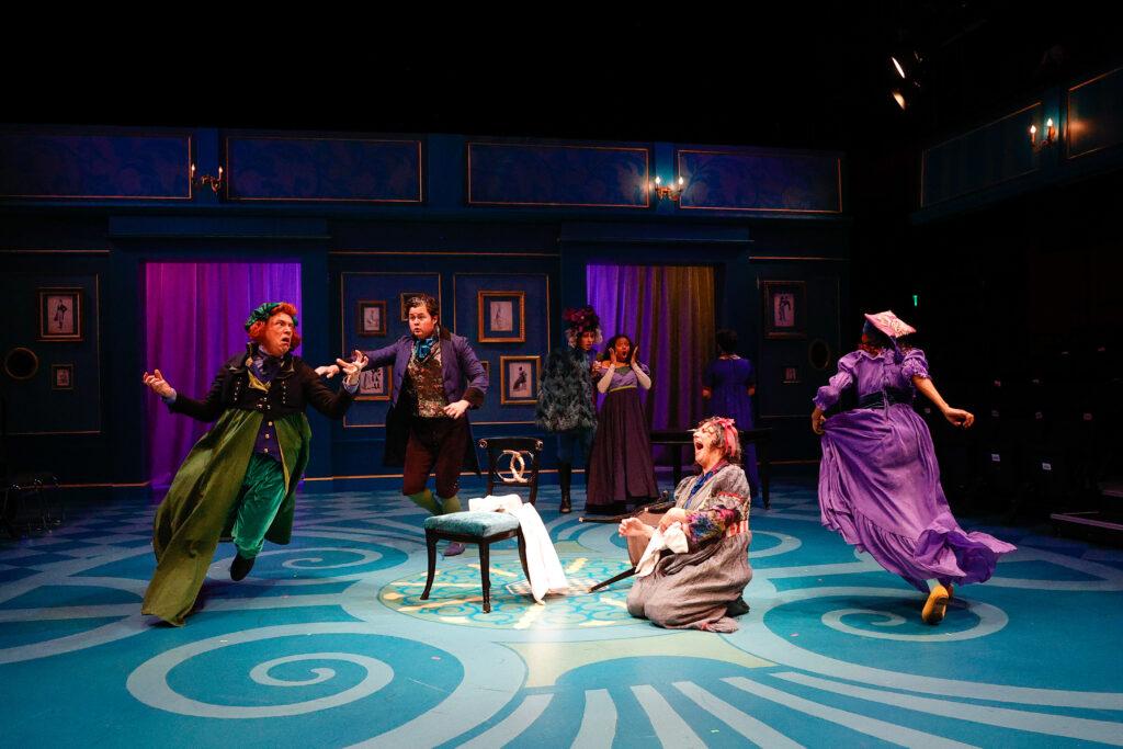 A lively scene from Sense &amp; Sensibility at Theatreworks, featuring a group of actors in colorful costumes on stage.