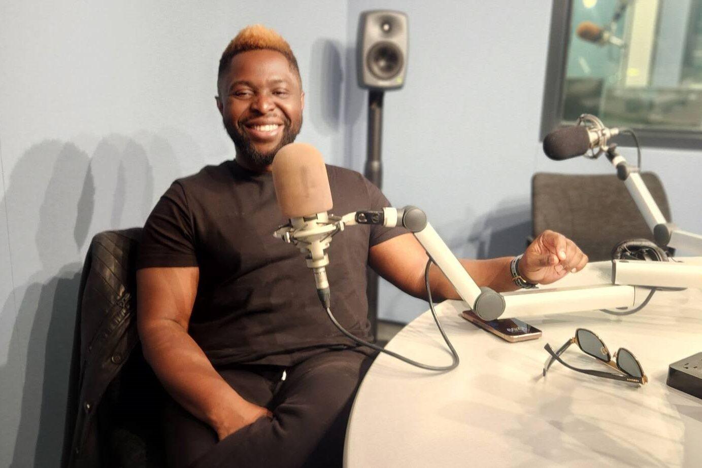 John Akinboyewa is pictured sitting in a CPR News studio.