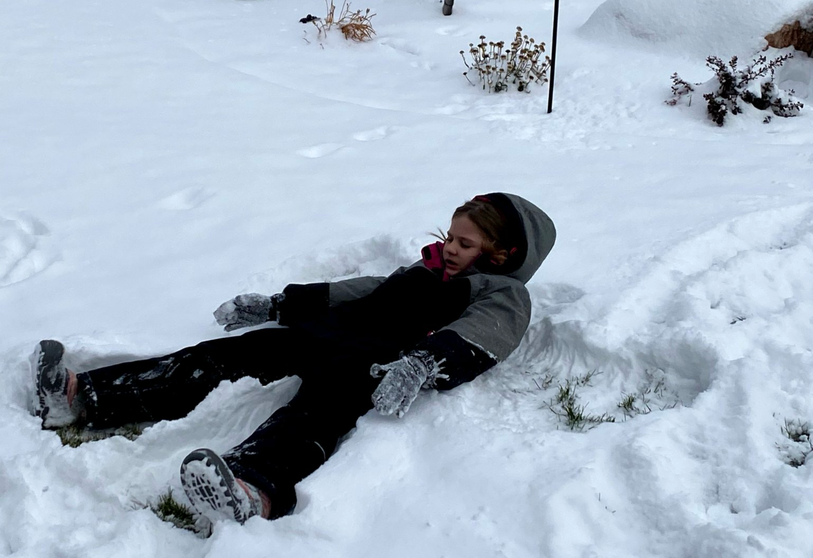 Emily makes a snow angel.