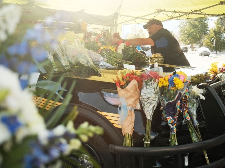 A memorial for Officer Dunn outside the Golden Police Department