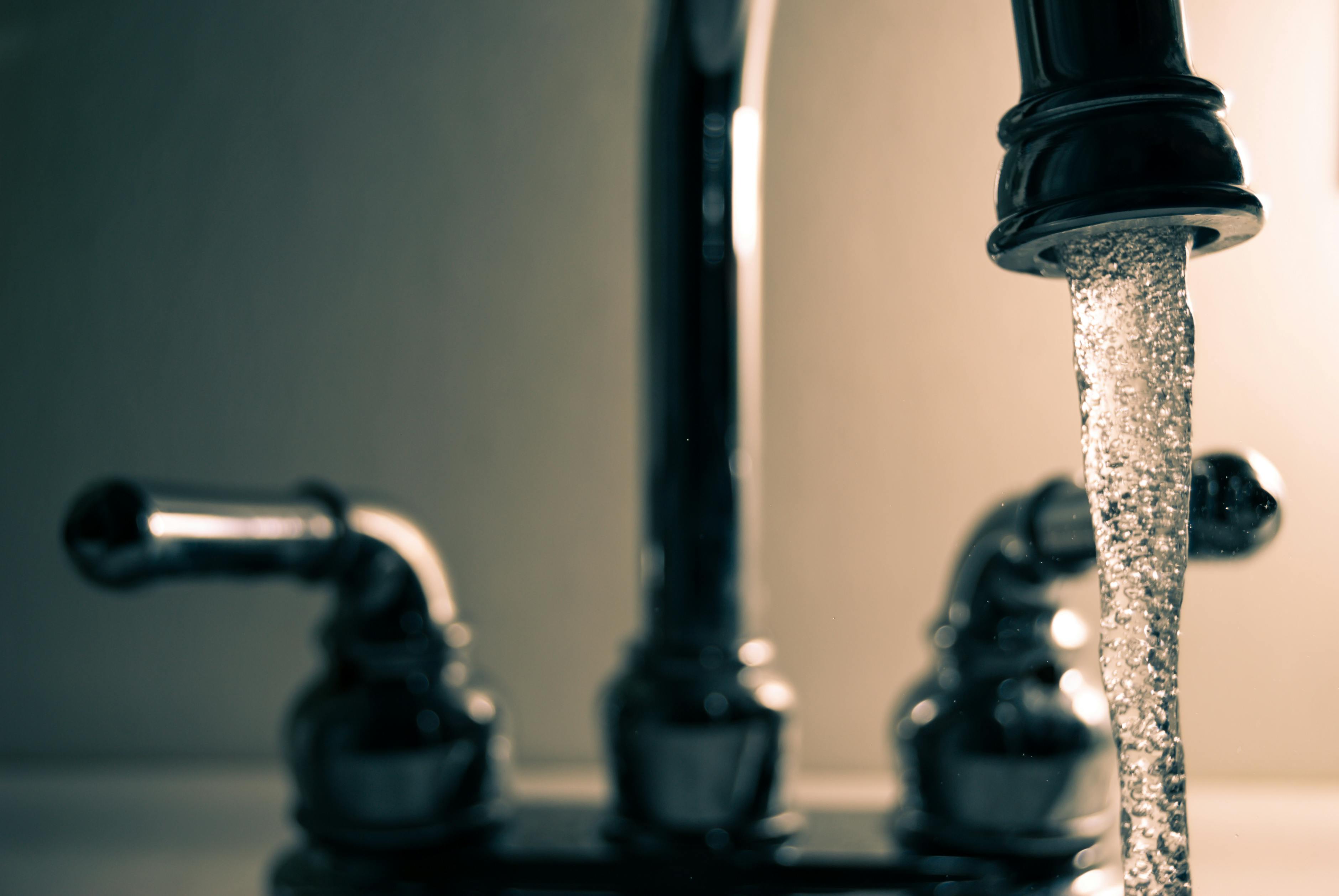 Clear water running from a kitchen tap.