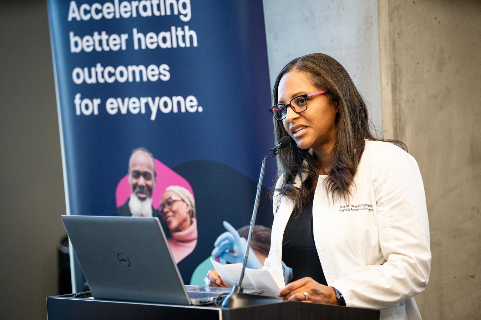 Surgeon and scientist Dr. Kia Washington speaks to reporters