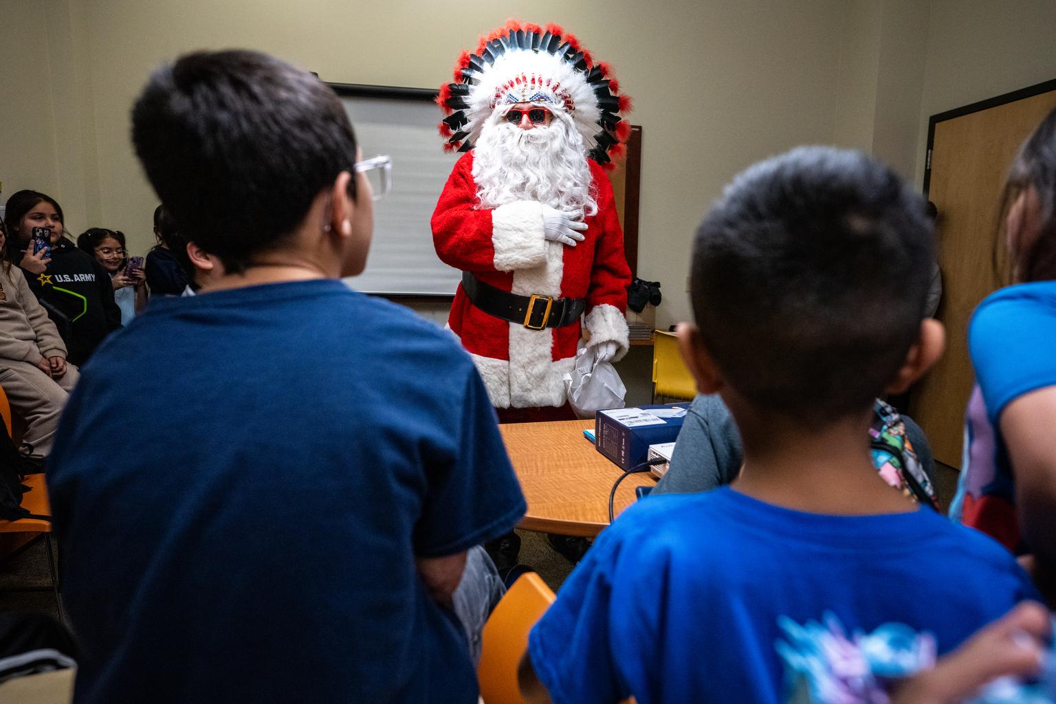 American Indian Santa stands in front of children