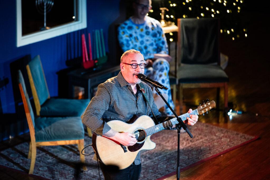 Rabbi Joe Black sings and plays guitar at the Colorado Matters Holiday Extravaganza