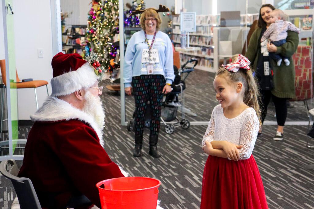 A santa greets a little girl at the Jefferson County Library