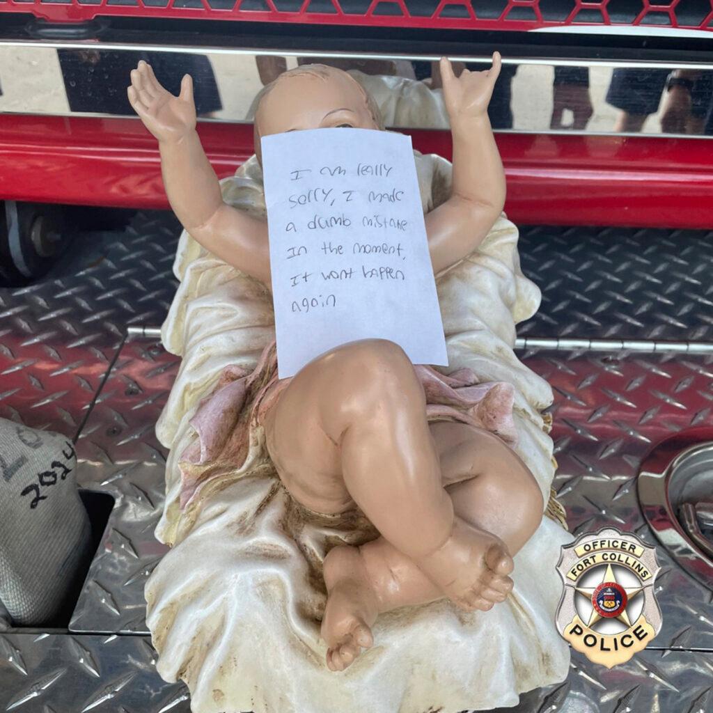 A stolen baby Jesus figurine with a handwritten apology note on top of it