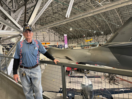 An 86-year-old man is seen standing by a railing overlooking airplanes on display at the Wings Over the Rockies museum in Denver in January 2024.