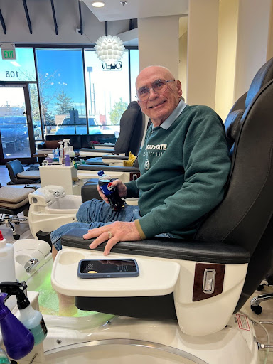 86-year-old Mel Brown is seen sitting in a chair for a pedicure.