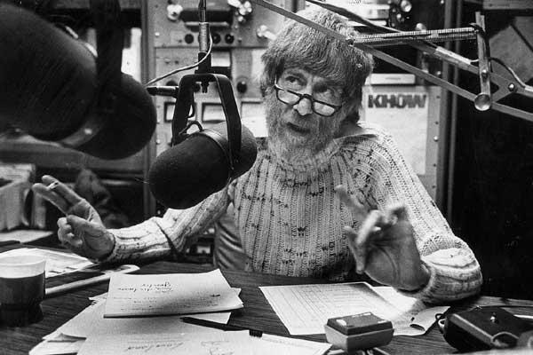 A black and white photo of former KOA talk show host Alan Berg at a studio microphone.