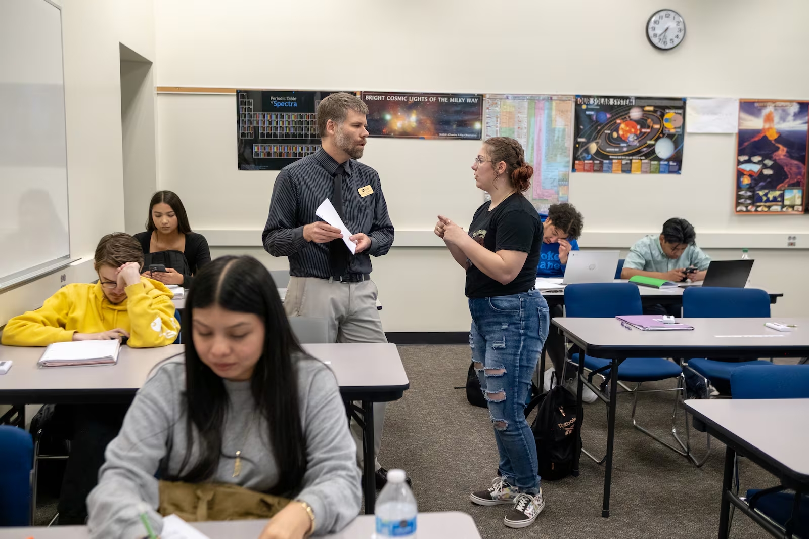 An ASCENT student talks with her instructor in an astronomy class at the Community College of Aurora Lowry Campus