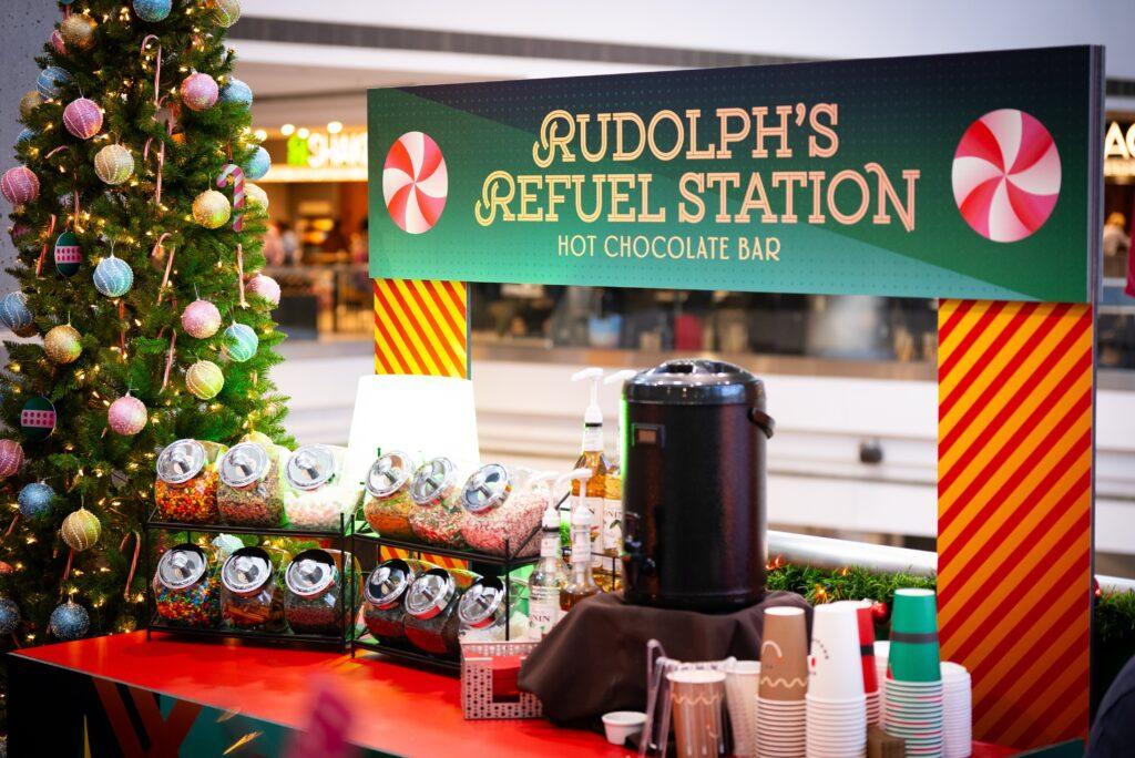 Photo shows the hot chocolate bar and fixings at Santa's Layover Lounge at DIA.