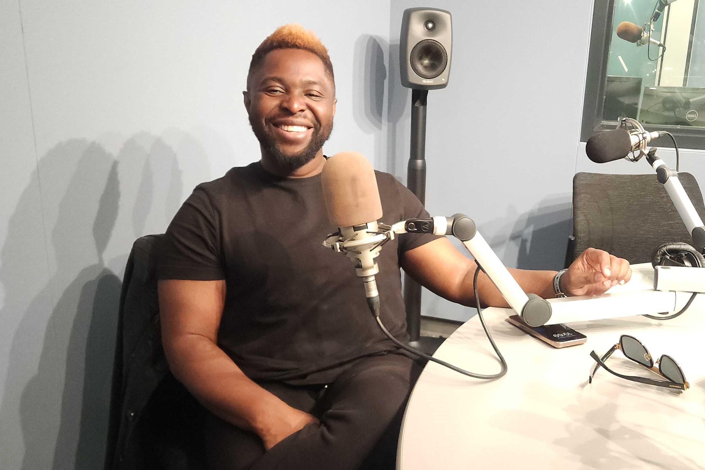 John Akinboyewa is pictured sitting in a CPR News studio.