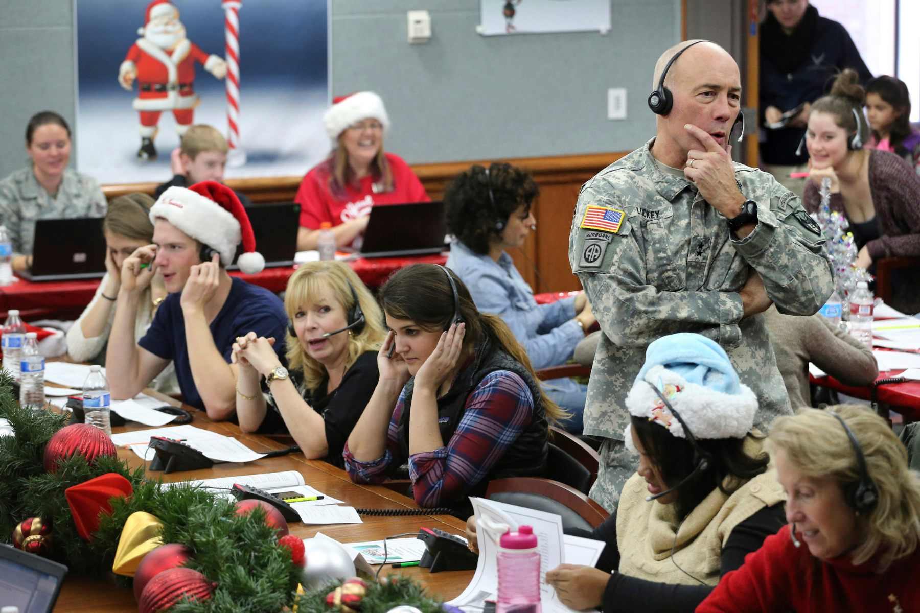 NORAD Chief of Staff Maj. Gen. Charles D. Luckey takes a call while volunteering at the NORAD Tracks Santa center