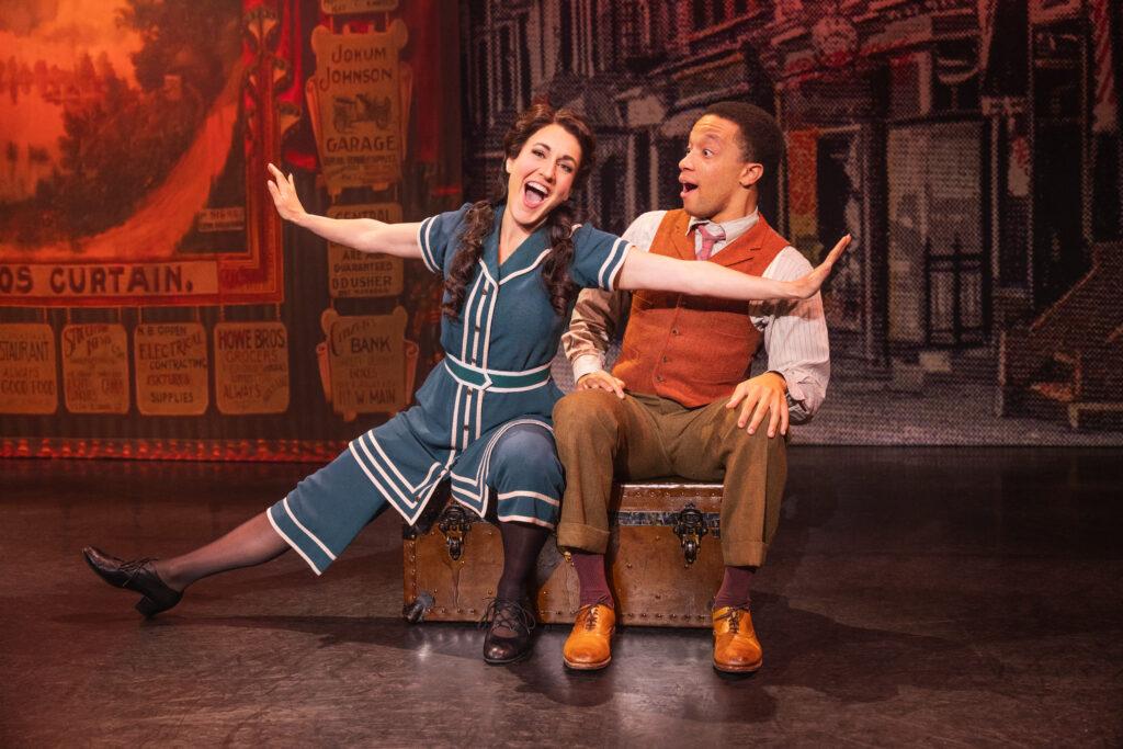 Two performers sit on a steamer trunk in a scene from the touring production of the musical &quot;Funny Girl.&quot;