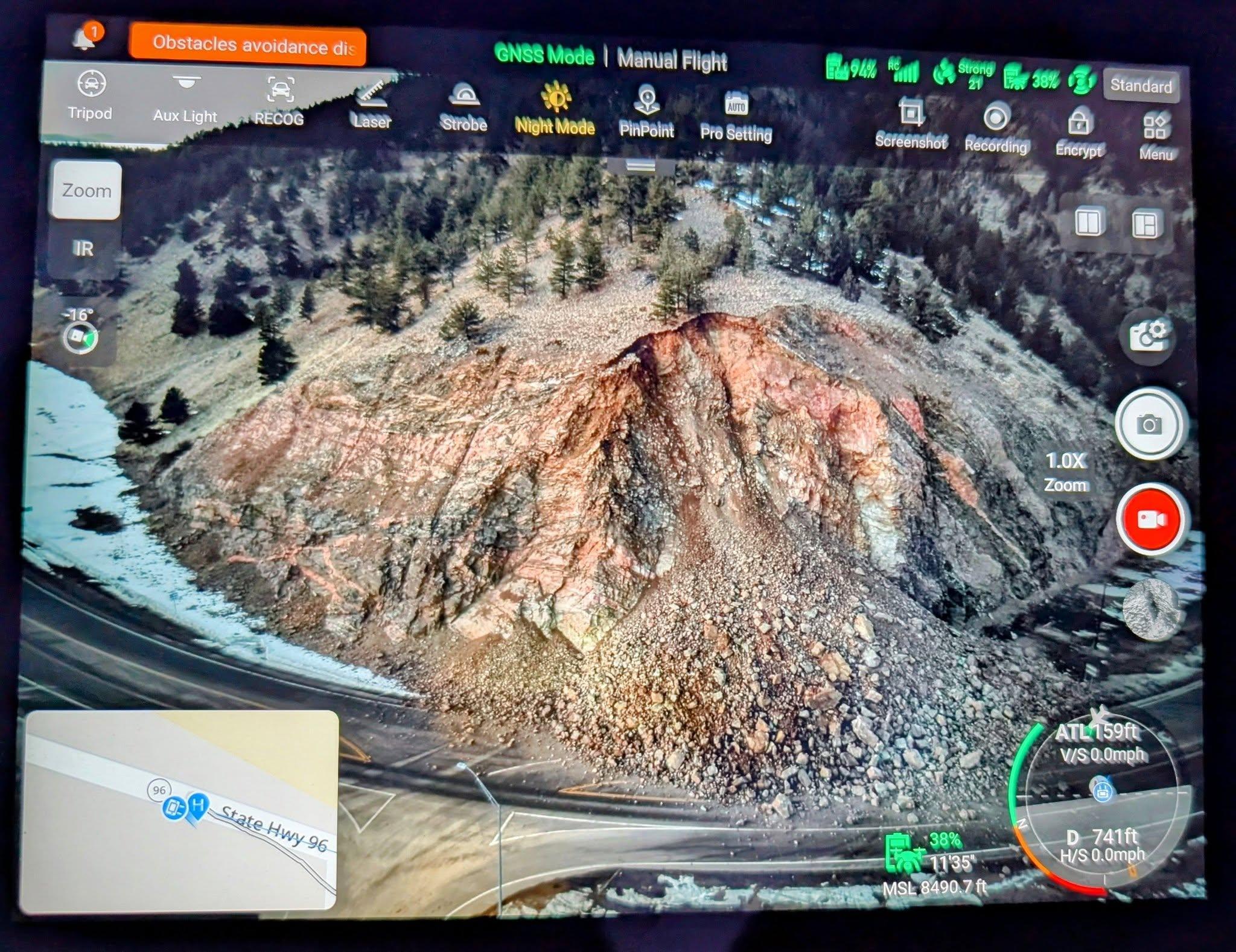 aerial view of rockslide covering roadway