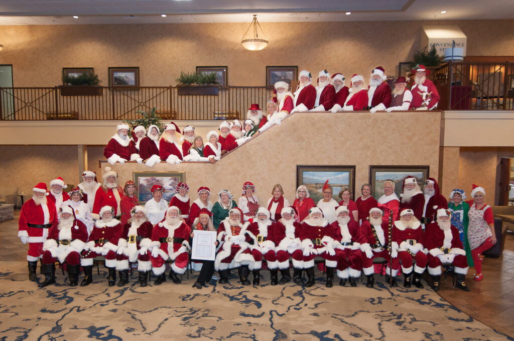 Santas graduating from the Professional Santa Claus School pose for class photo