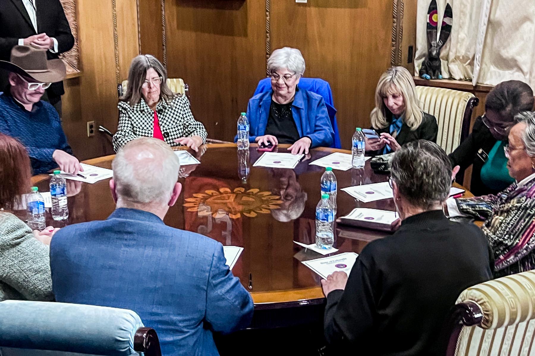 Sitting around a round table in the Governors office, the 10 different electors apart of Colorado's electoral college fill out the official Presidential ballot in front of them.