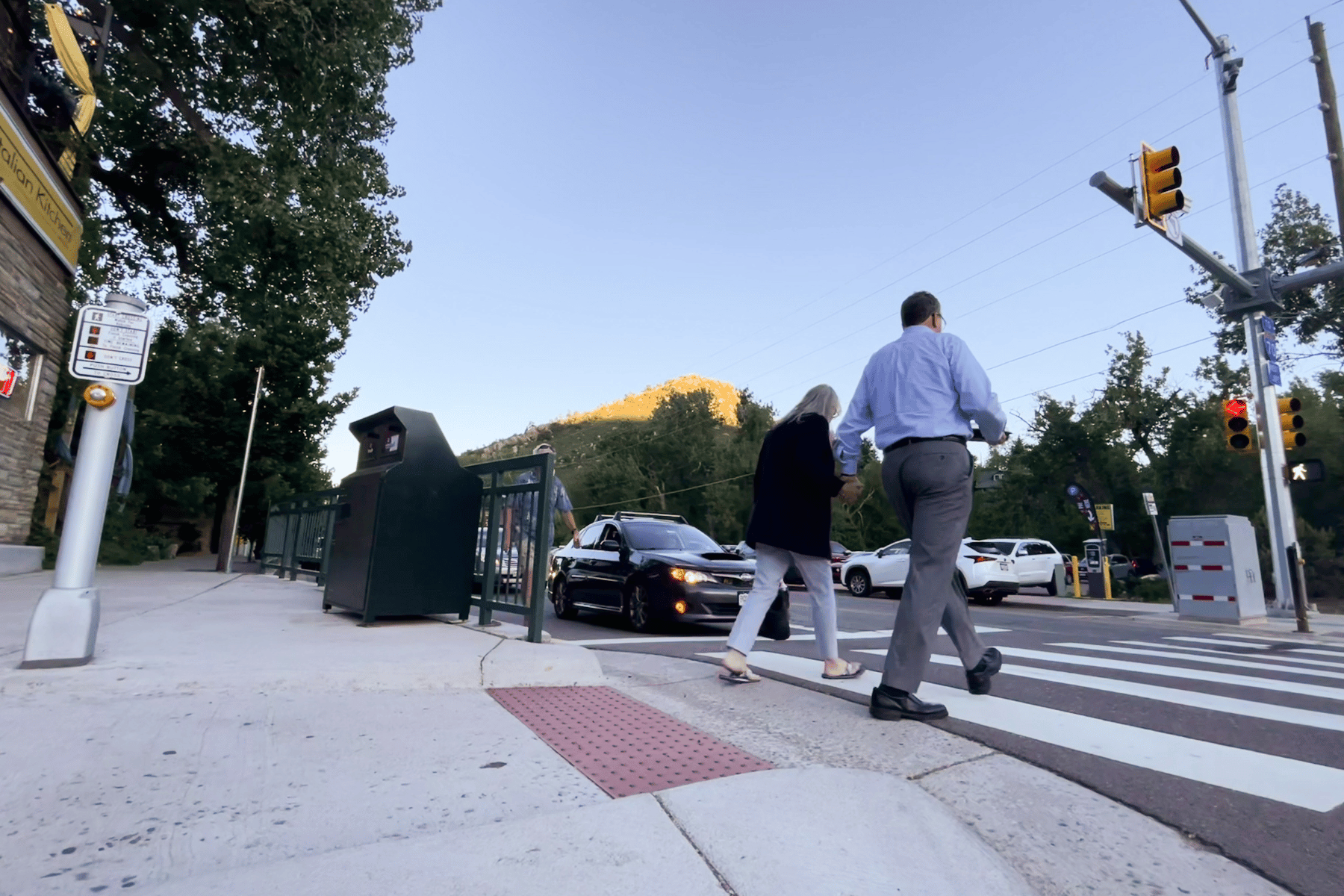 Pedestrians walk across Bear Creek Avenue in downtown Morrison