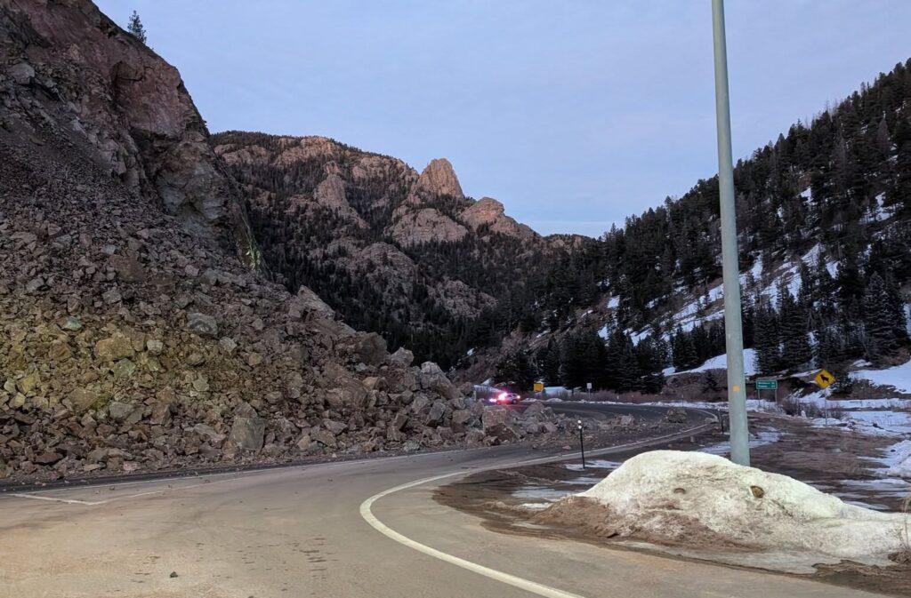 Large rocks cover road in mountainous area