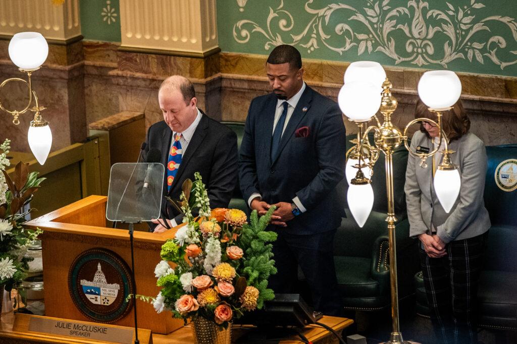 Gov. Jared Polis leads lawmakers and other dignitaries in a moment of silence for former President Jimmy Carter