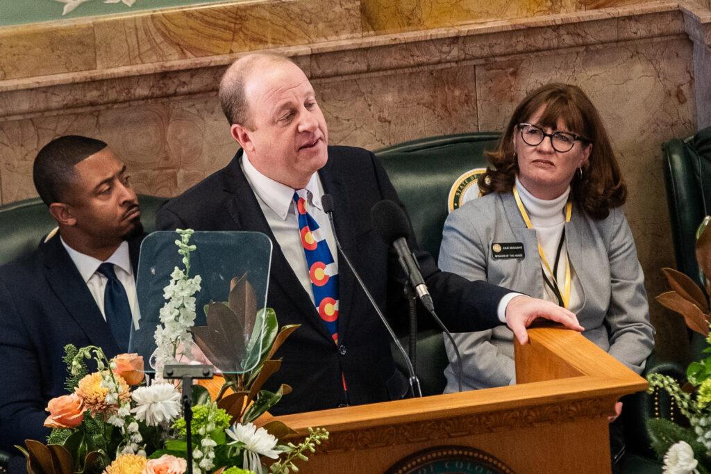 Gov. Jared Polis leads lawmakers and other dignitaries in a moment of silence for former President Jimmy Carter