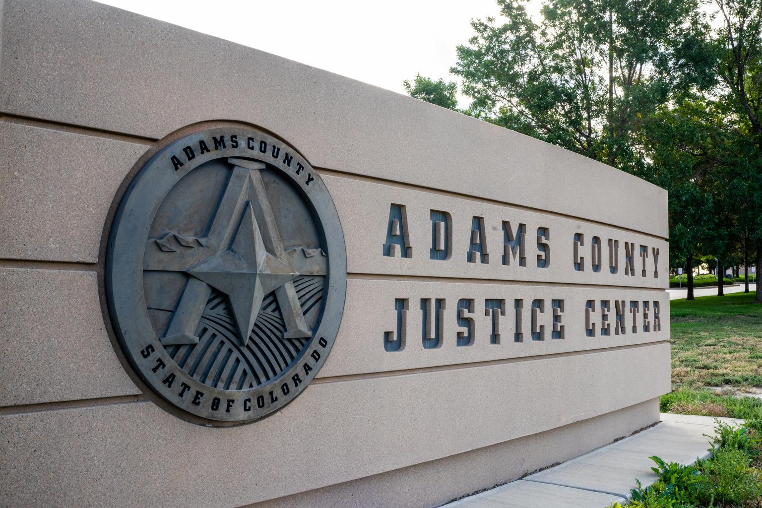 The Adams County Justice Center sign in Brighton