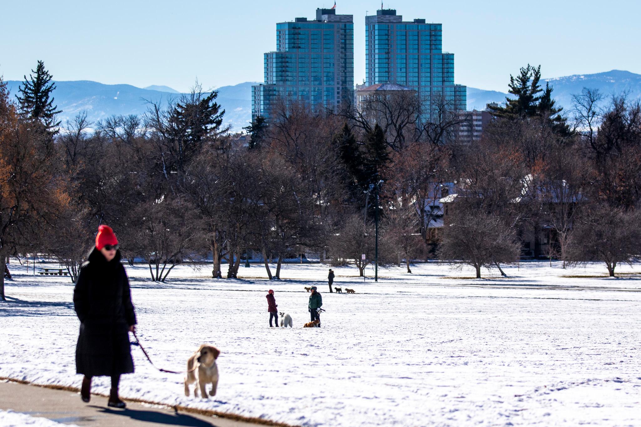 People in Cheesman Park with snow covering the ground and sun out