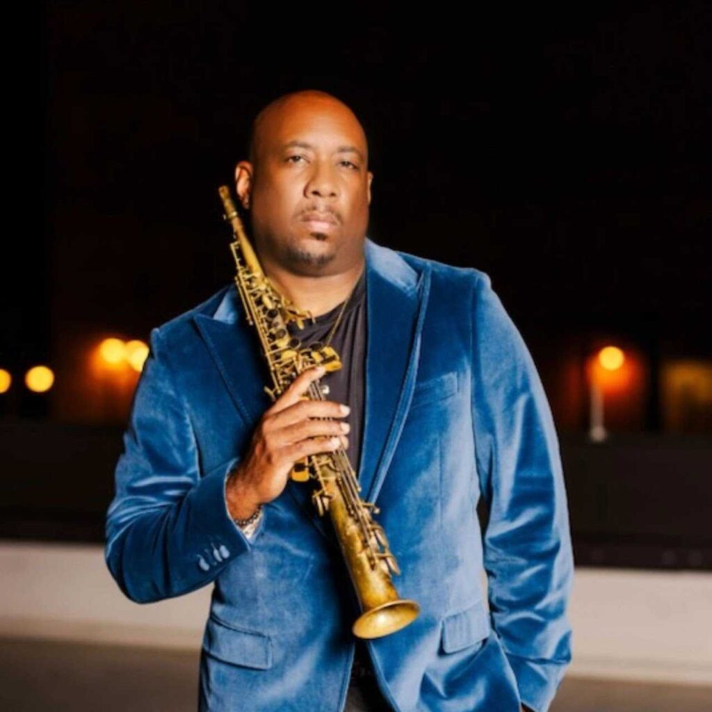 Colorado jazz musician Tony Exum, Jr. is seen standing, holding his soprano saxophone