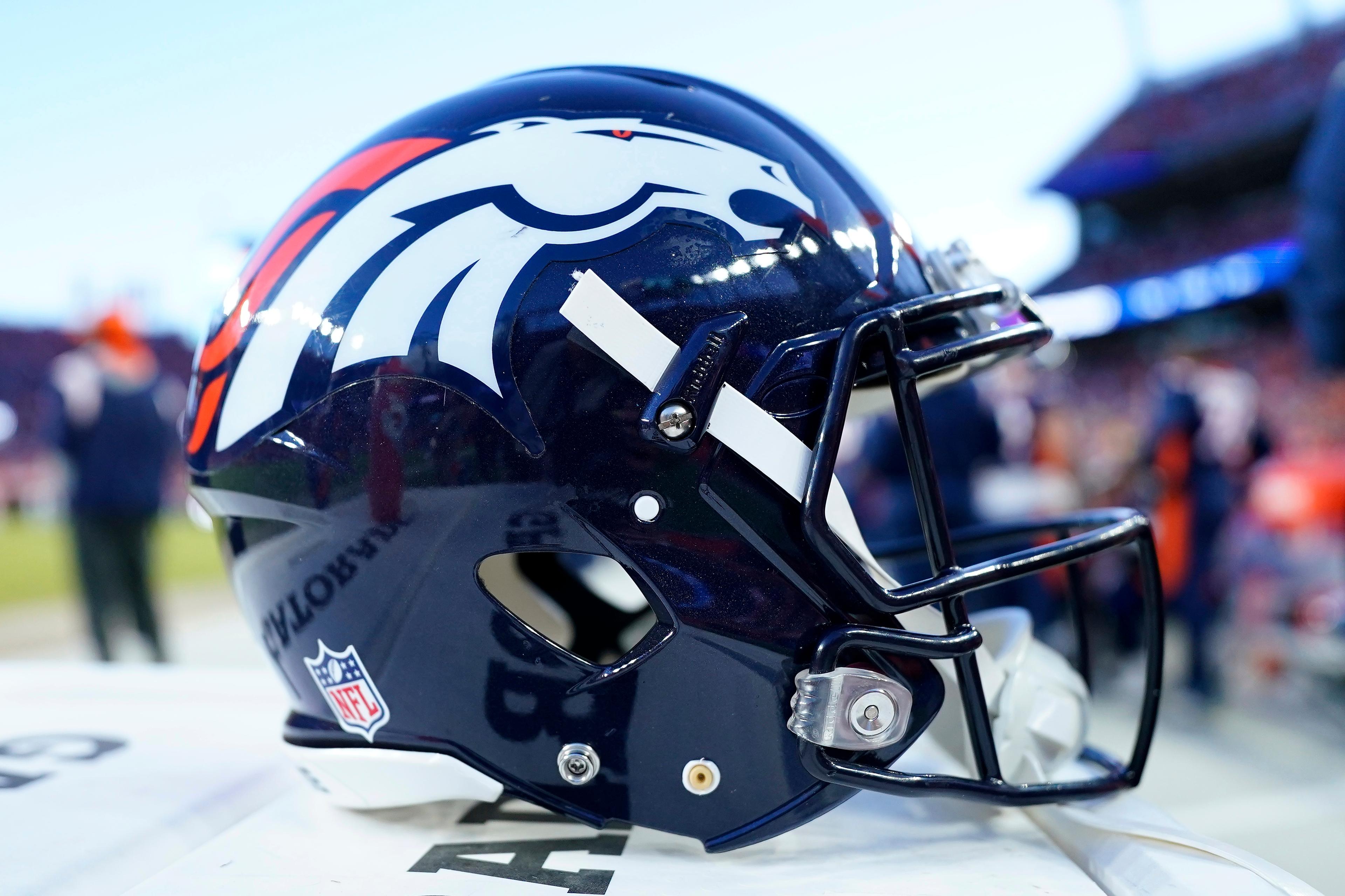 Denver Broncos helmet on a bench at an NFL game