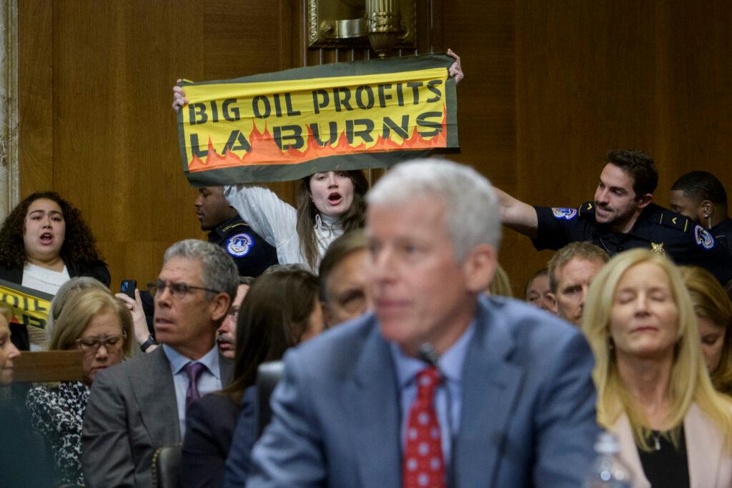 A protestor interrupts Chris Wright during a Senate Committee