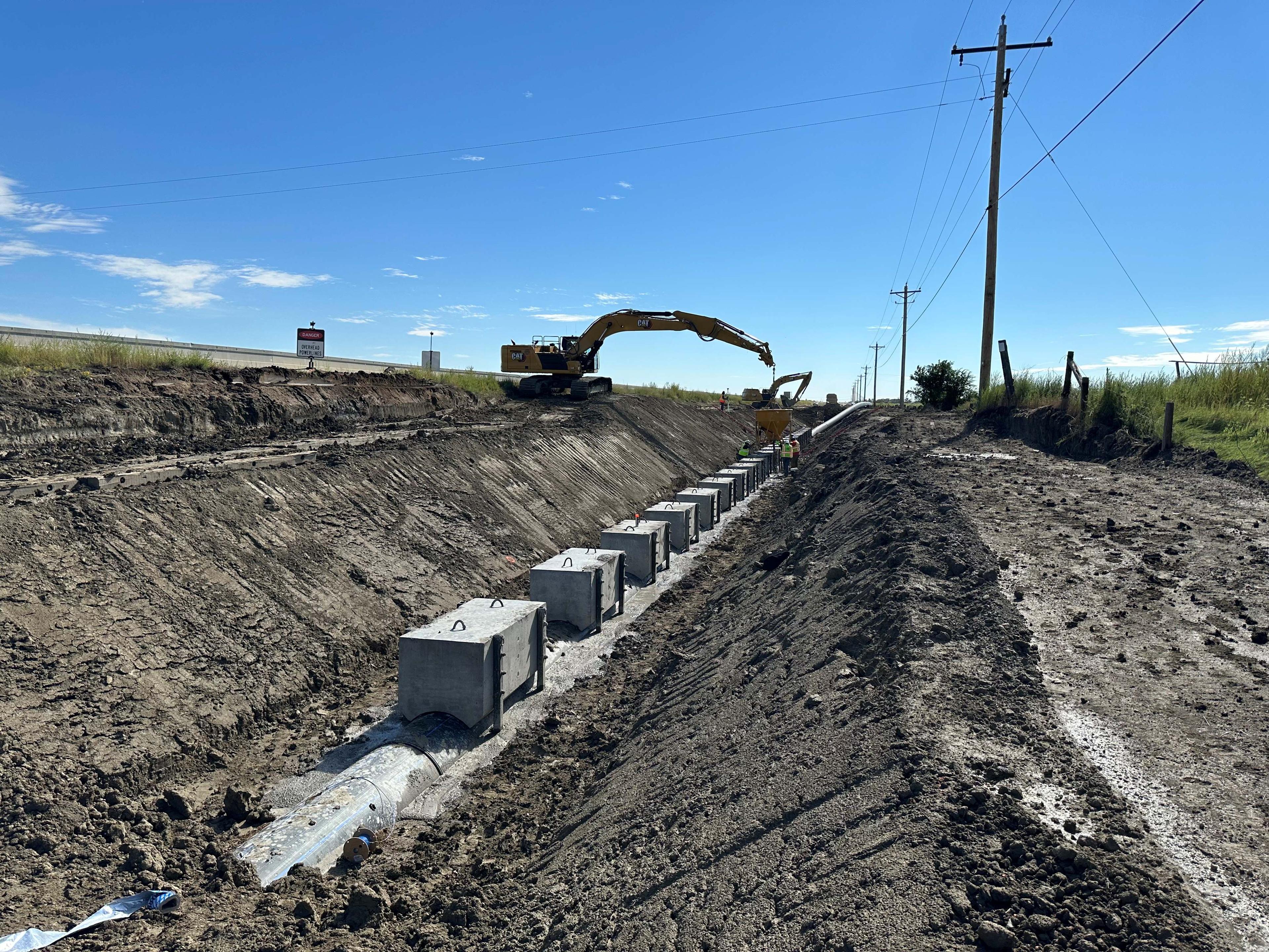 Heavy equipment and new pipeline in ditch