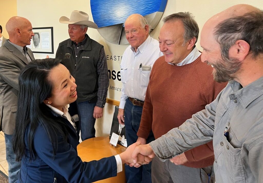 a person shakes hands with smiling people