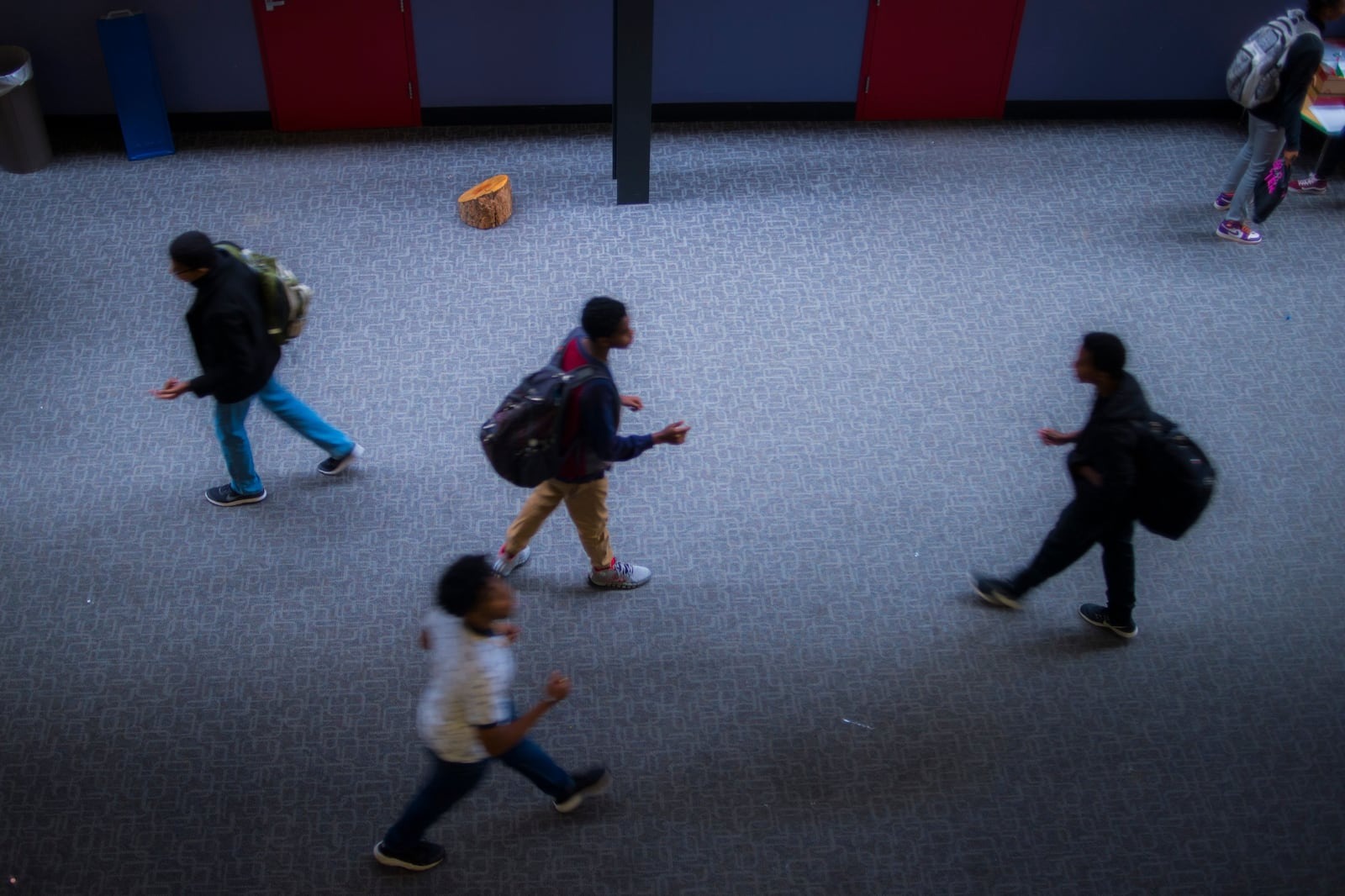 An overhead photo of students walking in the hallway